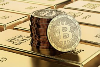 Picture of bitcoins sitting on top of a stack of gold bricks